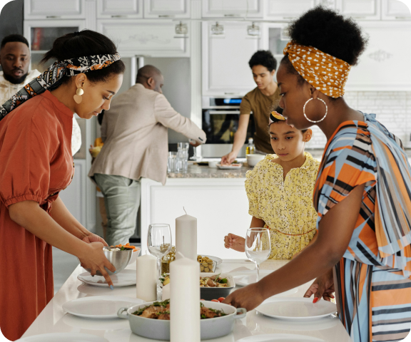 Family preparing food together in kitchen
